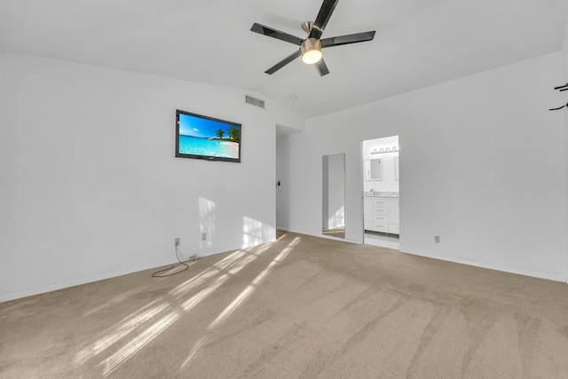 unfurnished bedroom with carpet flooring, vaulted ceiling, visible vents, and ensuite bathroom