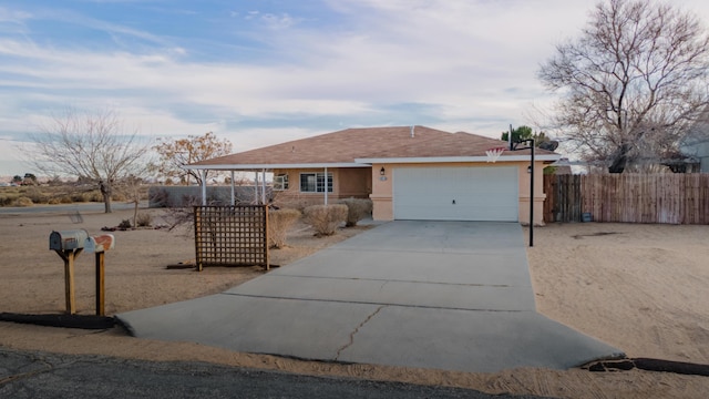 ranch-style home with roof with shingles, stucco siding, concrete driveway, fence, and a garage