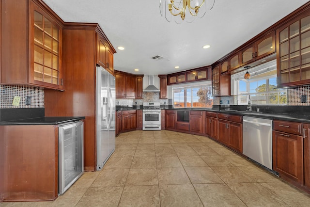 kitchen with beverage cooler, dark countertops, glass insert cabinets, stainless steel appliances, and wall chimney range hood