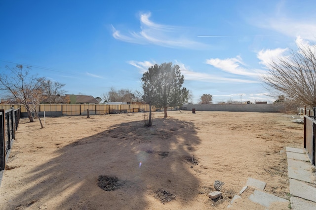 view of yard with a rural view and fence