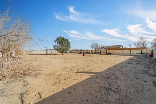 view of yard featuring fence and a rural view