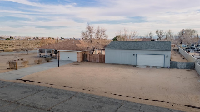 detached garage featuring fence