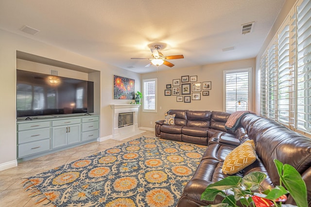 4104 Rainer Pl, Quartz Hill, CA 93536 - living area featuring healthy amount of natural light, baseboards, light tile patterned floors, and a glass covered fireplace
