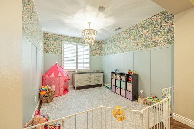 4104 Rainer Pl, Quartz Hill, CA 93536 - rec room with a chandelier, a wainscoted wall, wallpapered walls, and a decorative wall