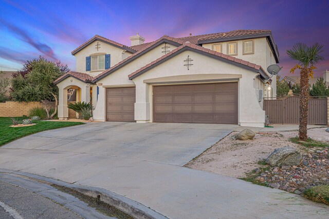 4104 Rainer Pl, Quartz Hill, CA 93536 - mediterranean / spanish house featuring driveway, a gate, stucco siding, and an attached garage