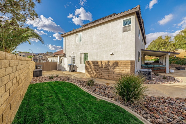 4104 Rainer Pl, Quartz Hill, CA 93536 - back of house with stucco siding, a gate, central AC unit, and a patio area
