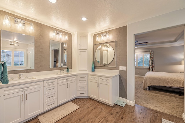 4104 Rainer Pl, Quartz Hill, CA 93536 - ensuite bathroom featuring baseboards, a textured ceiling, double vanity, recessed lighting, and wood finished floors