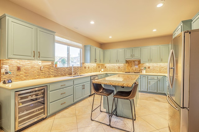 4104 Rainer Pl, Quartz Hill, CA 93536 - kitchen with stainless steel appliances, beverage cooler, a sink, light countertops, and a center island