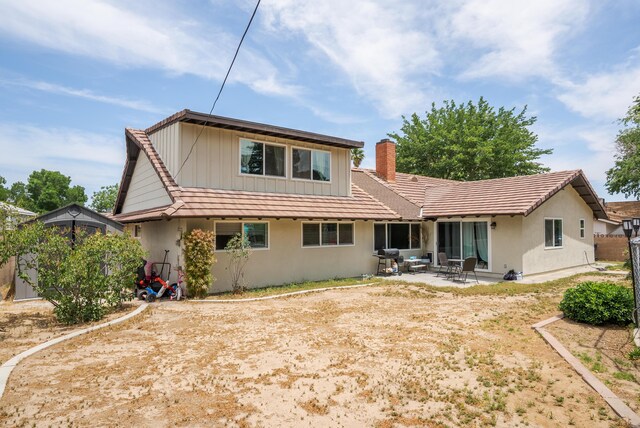 43818 Halcom Ave, Lancaster, CA 93536 - rear view of property featuring a patio, a chimney, and stucco siding