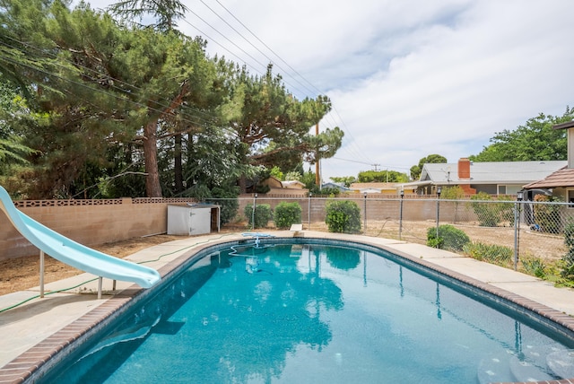43818 Halcom Ave, Lancaster, CA 93536 - view of swimming pool with a water slide, a fenced backyard, and a diving board