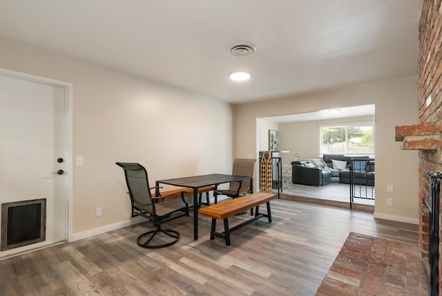 43818 Halcom Ave, Lancaster, CA 93536 - dining room with wood finished floors, a fireplace, and baseboards