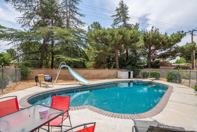 43818 Halcom Ave, Lancaster, CA 93536 - view of pool with a water slide, a fenced backyard, a patio, and a diving board