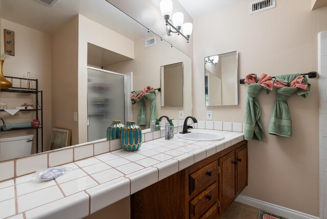 43818 Halcom Ave, Lancaster, CA 93536 - bathroom with a shower stall, vanity, toilet, tile patterned floors, and baseboards