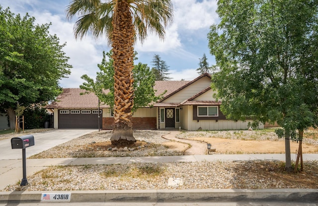 43818 Halcom Ave, Lancaster, CA 93536 - view of front facade featuring an attached garage, a tiled roof, and driveway