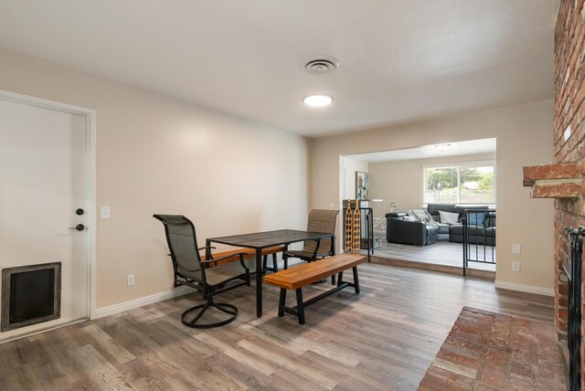 43818 Halcom Ave, Lancaster, CA 93536 - dining room with wood finished floors, a fireplace, and baseboards