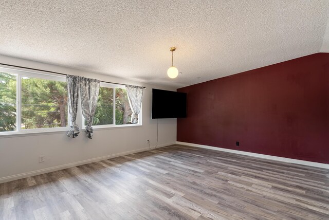 43818 Halcom Ave, Lancaster, CA 93536 - spare room featuring a textured ceiling, wood finished floors, and baseboards