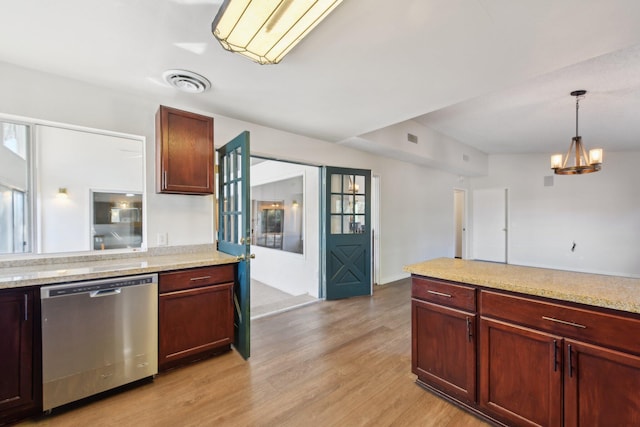 kitchen with stainless steel dishwasher, visible vents, light wood finished floors, and an inviting chandelier