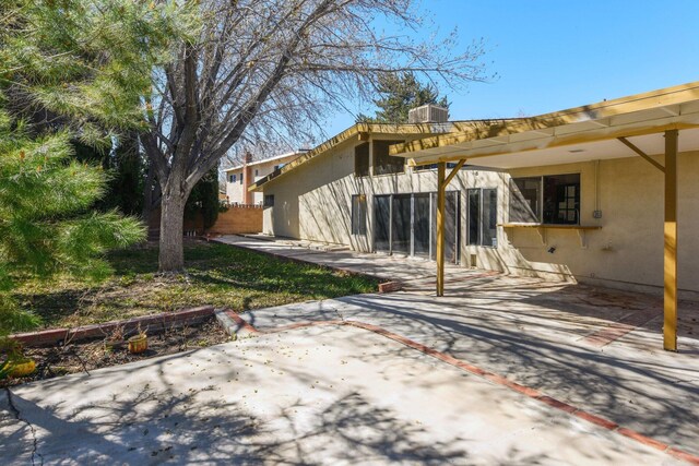 exterior space featuring a patio, central AC unit, and stucco siding