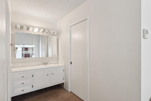 bathroom with vanity and a textured ceiling