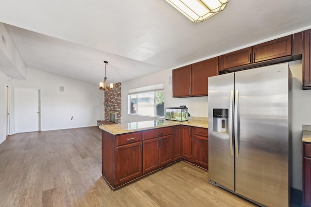 kitchen with lofted ceiling, a peninsula, light wood-style floors, and stainless steel refrigerator with ice dispenser