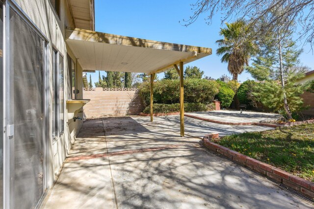 view of patio / terrace featuring fence