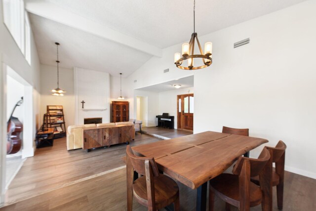 dining room featuring high vaulted ceiling, beamed ceiling, visible vents, a notable chandelier, and wood finished floors