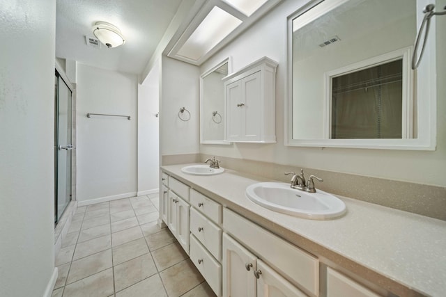 full bathroom featuring double vanity, a sink, visible vents, and a shower stall