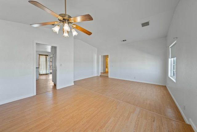 empty room with light wood-style floors, lofted ceiling, visible vents, and ceiling fan