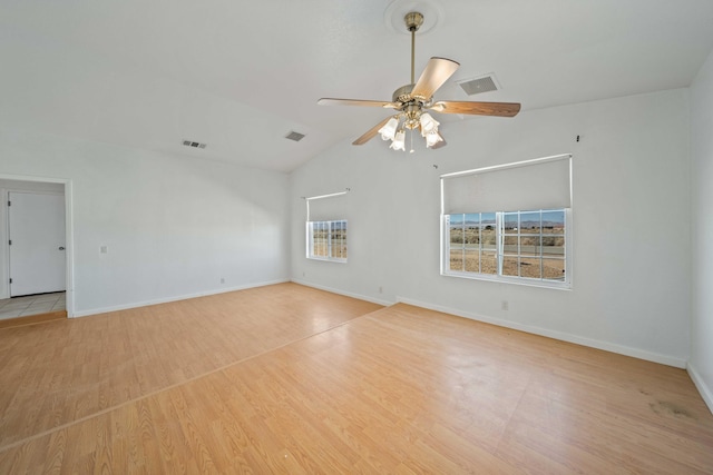 unfurnished room featuring vaulted ceiling, wood finished floors, and visible vents