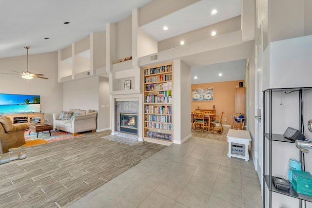 living room featuring visible vents, high vaulted ceiling, a ceiling fan, recessed lighting, and a fireplace