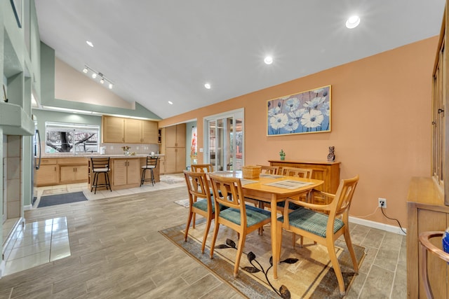 dining room featuring recessed lighting, baseboards, wood tiled floor, and vaulted ceiling