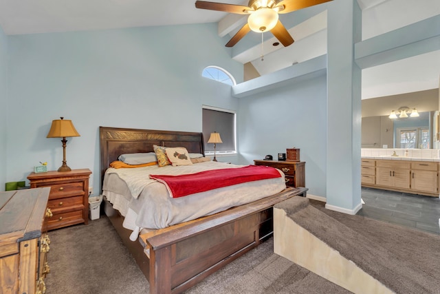 bedroom with connected bathroom, baseboards, beamed ceiling, dark carpet, and high vaulted ceiling