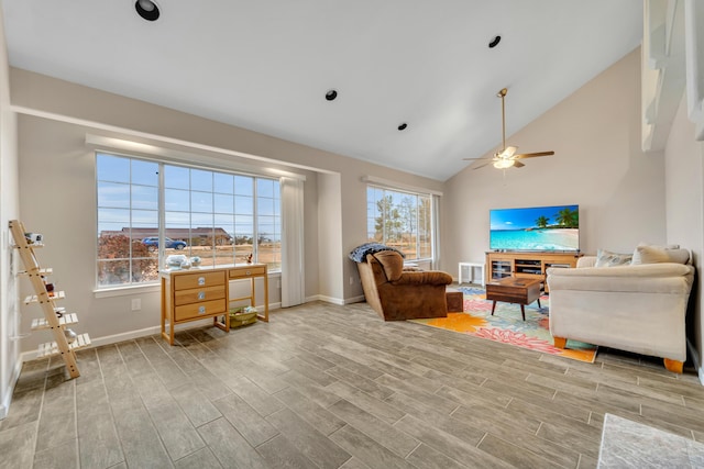 living area with a healthy amount of sunlight, baseboards, and wood tiled floor