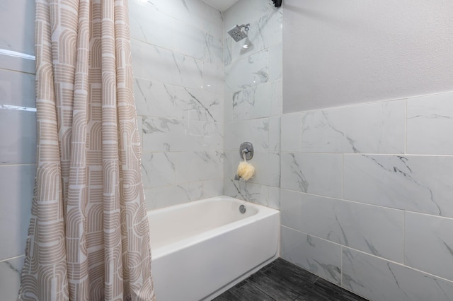 bathroom with shower / bath combination with curtain, tile walls, and hardwood / wood-style flooring