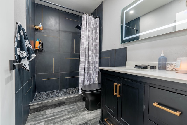 bathroom with vanity, toilet, and curtained shower