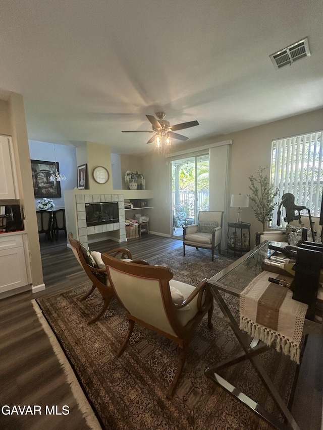 38836 Calistoga St, Palmdale, CA 93551 - living room with dark wood-style flooring, a tile fireplace, and ceiling fan