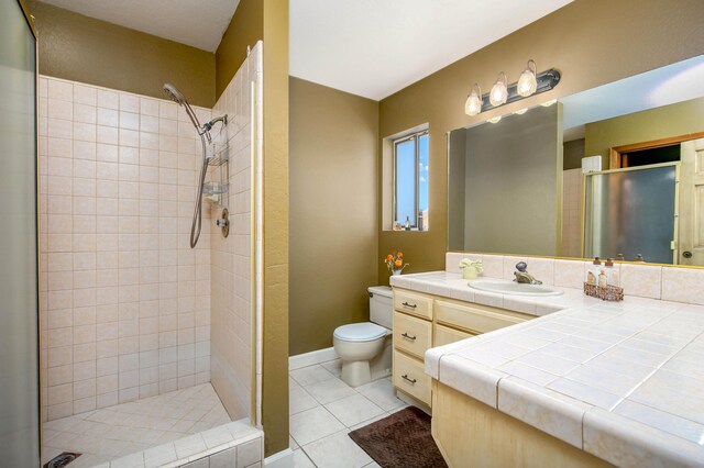 3215 Larwood Dr, Lancaster, CA 93536 - full bathroom with vanity, tile patterned floors, a stall shower, and toilet