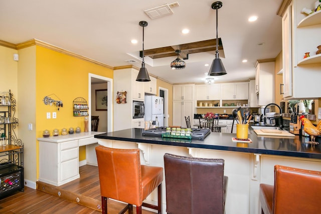 3215 Larwood Dr, Lancaster, CA 93536 - kitchen featuring visible vents, open shelves, dark wood-style flooring, a peninsula, and appliances with stainless steel finishes