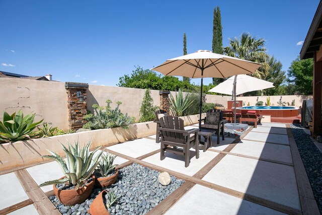 3215 Larwood Dr, Lancaster, CA 93536 - view of patio featuring a fenced backyard, a jacuzzi, and an outdoor hangout area