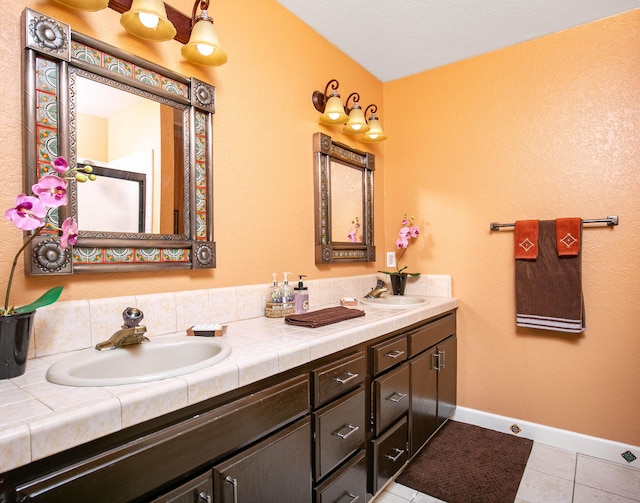 3215 Larwood Dr, Lancaster, CA 93536 - bathroom with a sink, tile patterned floors, baseboards, and double vanity
