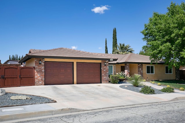3215 Larwood Dr, Lancaster, CA 93536 - ranch-style home with stucco siding, a gate, a tiled roof, concrete driveway, and an attached garage