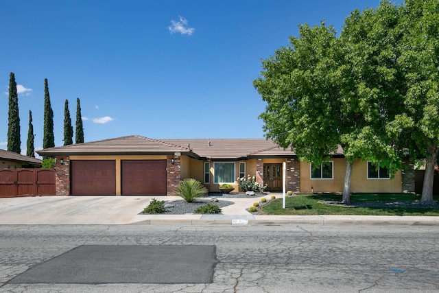 3215 Larwood Dr, Lancaster, CA 93536 - ranch-style house with a tiled roof, driveway, a garage, fence, and stucco siding