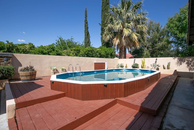 3215 Larwood Dr, Lancaster, CA 93536 - view of pool with fence, a wooden deck, and a jacuzzi