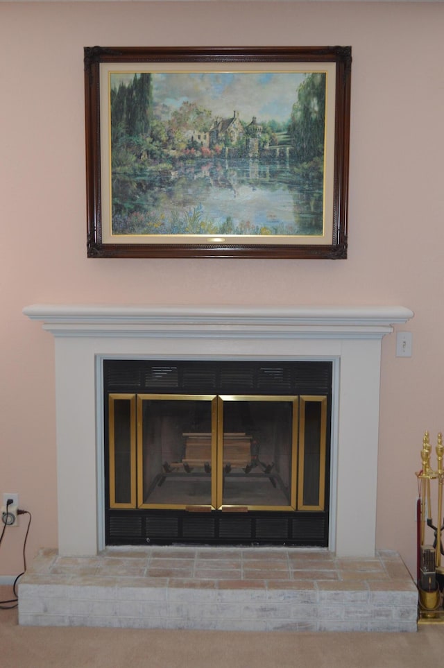 interior details featuring a glass covered fireplace