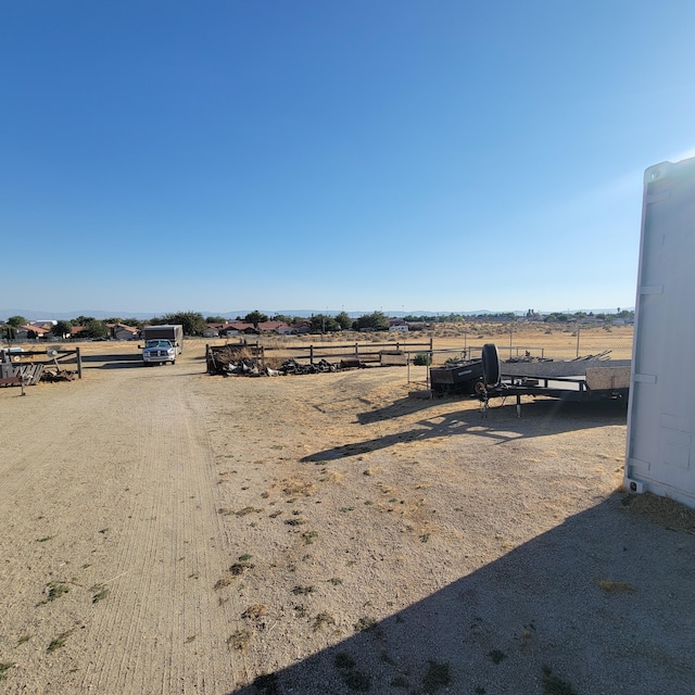 view of yard featuring a rural view and fence