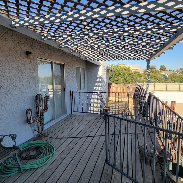 wooden terrace featuring fence and a pergola