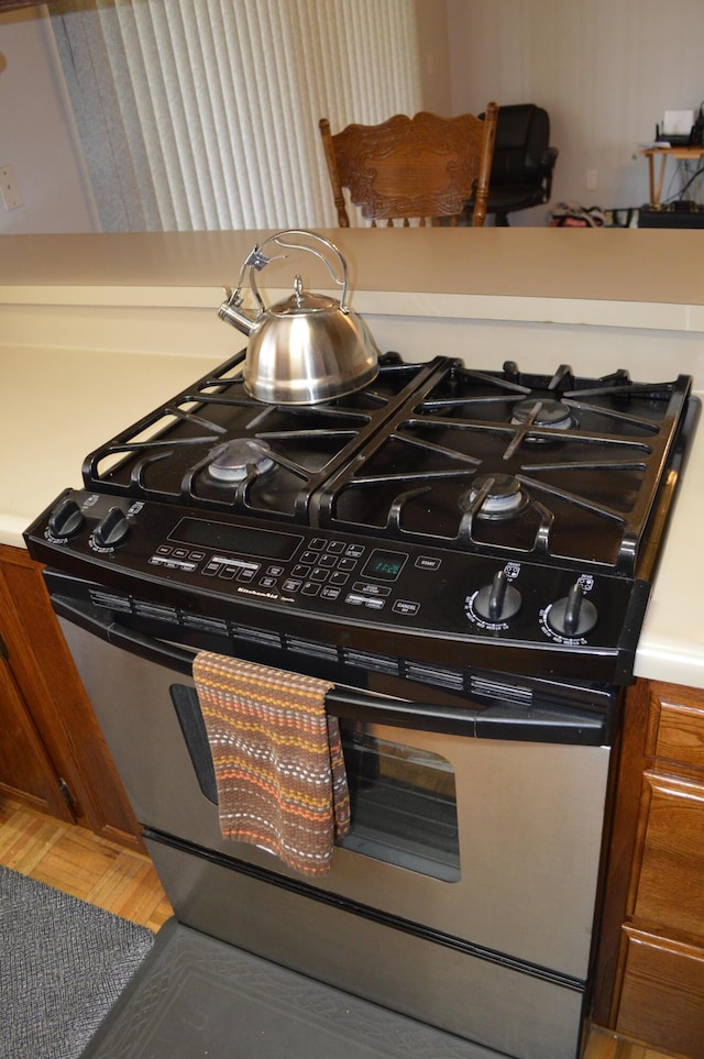 kitchen with light countertops and stainless steel range with gas stovetop