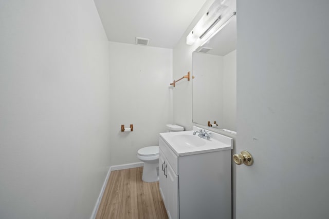 bathroom featuring hardwood / wood-style floors, vanity, and toilet