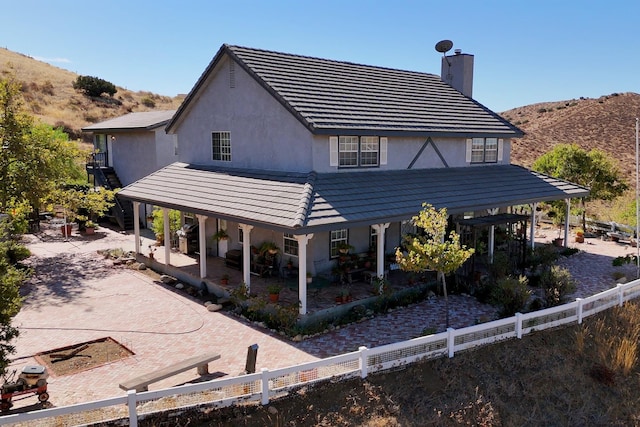 rear view of property featuring a mountain view