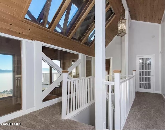 30508 Buckskin Dr, Tehachapi, CA 93561 - hallway featuring carpet floors, a wood ceiling with exposed beams, high vaulted ceiling, an upstairs landing, and a chandelier